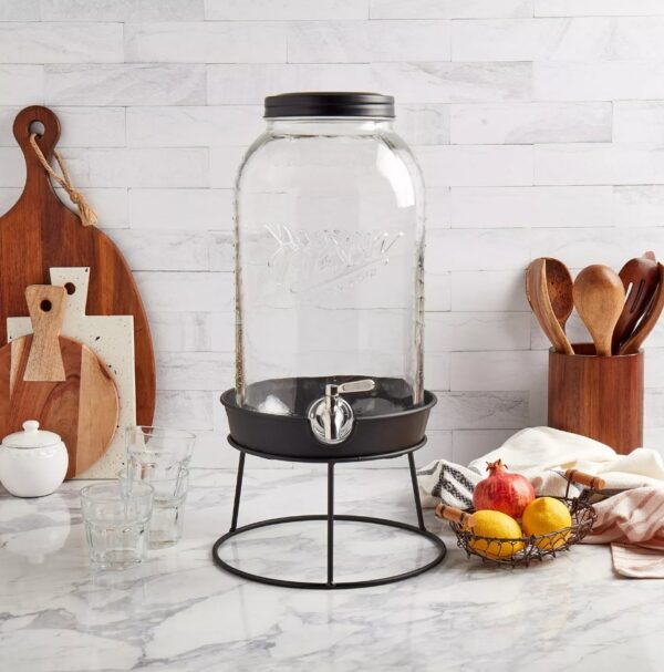 Mason Craft & More 11-Liter Glass Drink Dispenser with Metal Rack This 2.9 gallon Glass Drink Dispenser from Mason Craft & More delivers convenience and vintage style to your kitchen, whether you're serving fresh lemonade or homemade sangrias. Practical and easy to use, this drink dispenser includes a screw-top lid and wide mouth for simple filling with a leakproof, stainless-steel spigot. Glass is BPA-free, stain and odor-resistant Leakproof, stainless-steel spigot is easy to use and built to last Tight-fitting, screw-top lid keeps dust out and allows for quick refilling Adds vintage charm or modern farmhouse style to your kitchen design Ideal for showing off colorful drink creations at parties, serving water or lemonade in the backyard Vintage embossed design features the classic Mason Craft and More logo